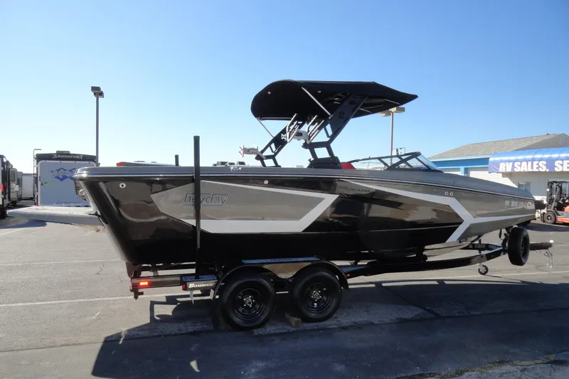 Slide: The Image of 2022 Heyday WT Surf boat on trailer, parked outdoors near RV sales. - 5