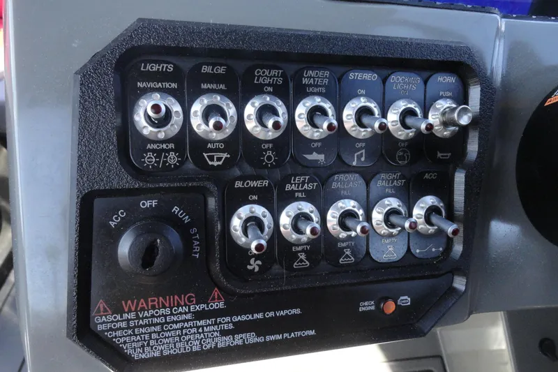 Slide: The Image of Control panel of a 2022 Heyday WT Surf boat with various switches and ignition. - 10