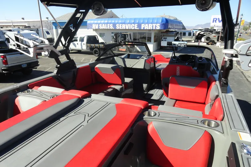 Slide: The Image of 2022 Heyday WT Surf boat interior with red and gray seating at RV sales lot. - 14
