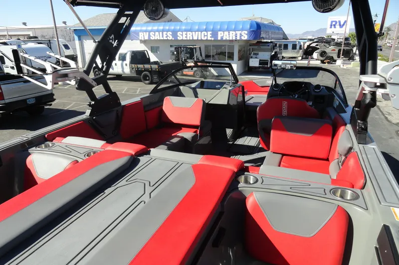 Slide: The Image of 2022 Heyday WT Surf boat with red and gray interior at RV sales lot. - 15