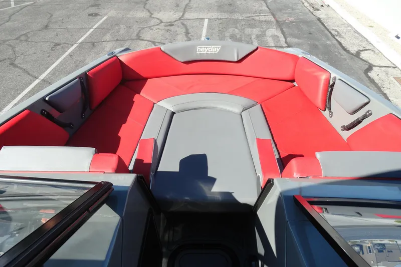 Slide: The Image of 2022 Heyday WT Surf boat interior with red and gray seating. - 16