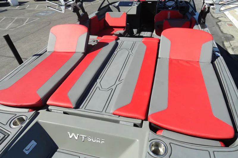 Slide: The Image of 2022 Heyday WT Surf boat with red and gray seating, showcasing modern design. - 22
