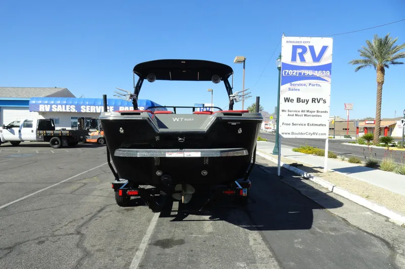Slide: The Image of 2022 Heyday WT Surf boat parked at RV sales lot under clear blue sky. - 27