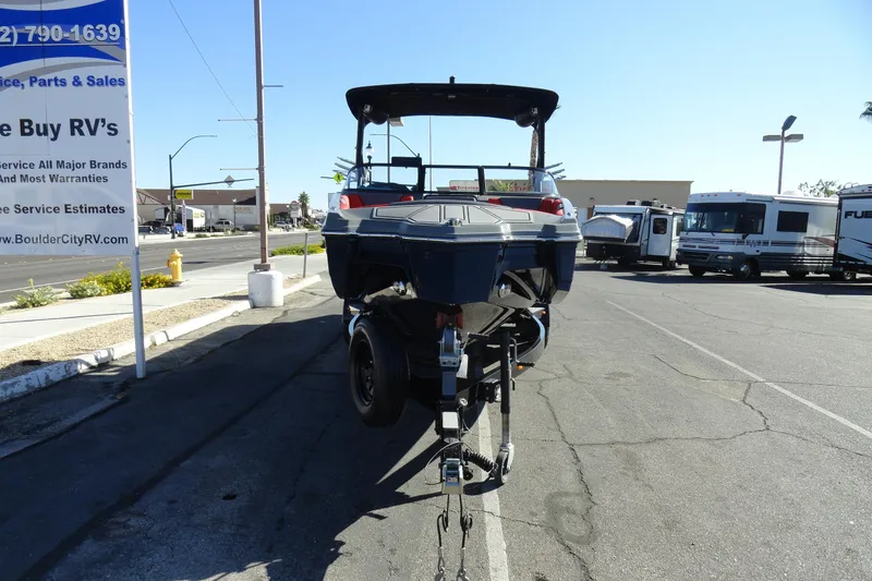 Slide: The Image of 2022 Heyday WT Surf boat on trailer in parking lot near RV dealership. - 3