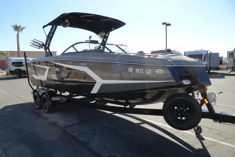 Slide: The Image of 2022 Heyday WT Surf boat on trailer in parking lot, side view. - 4