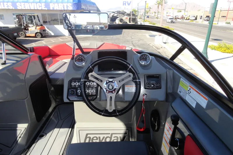 Slide: The Image of 2022 Heyday WT Surf boat dashboard with steering wheel and control panel. - 8
