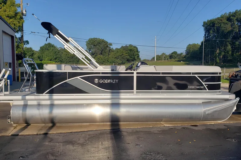 Slide: The Image of 2026 Godfrey 2086C SE pontoon boat parked outdoors on a sunny day. - 1