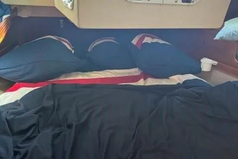 Slide: The Image of Cozy cabin interior of 1988 C&C 44 sailboat with neatly arranged bedding. - 11