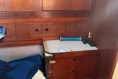 Slide: The Image of Interior of 1988 C&C 44 sailboat with wooden cabinetry and storage area. - 12