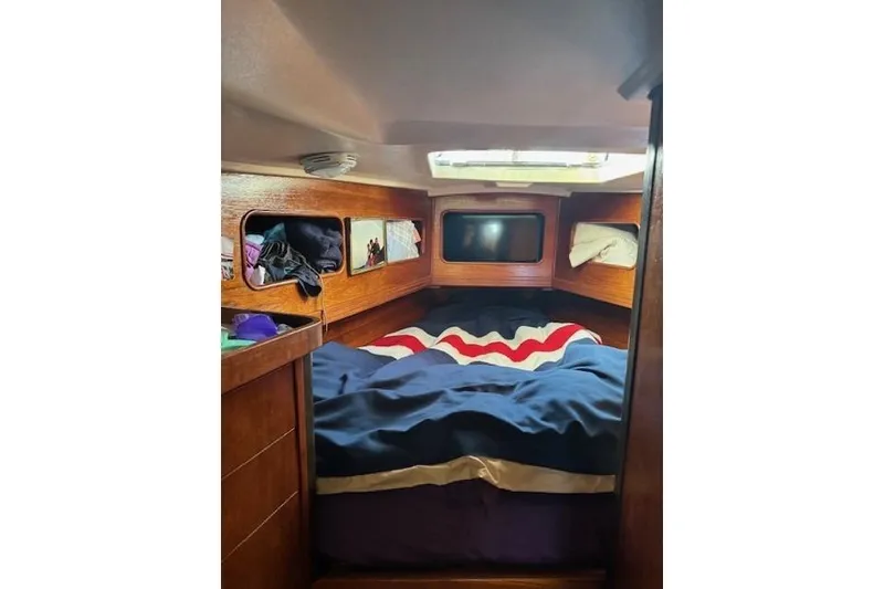 Slide: The Image of Cozy cabin interior of 1988 C&C 44 sailboat with wooden finish and bed. - 13