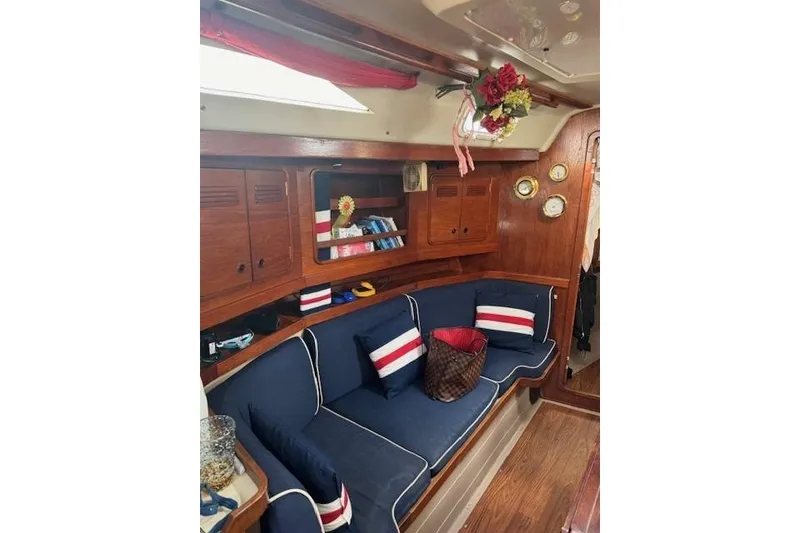 Slide: The Image of Interior of 1988 C&C 44 sailboat with blue seating, wooden cabinets, and nautical decor. - 4