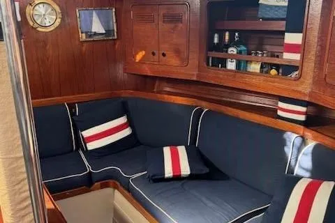 Slide: The Image of Cozy interior of 1988 C&C 44 sailboat with navy seating and nautical decor. - 6
