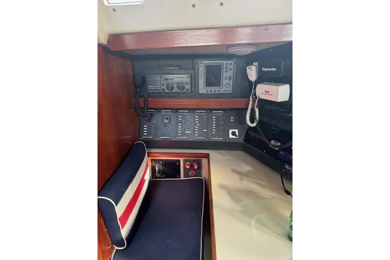 Slide: The Image of Navigation station inside 1988 C&C 44 sailboat with control panels and communication equipment. - 7