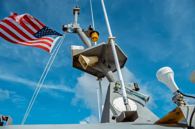 Slide: The Image of American flag on Kvichak Marine Industries Pilot boat, 2004, against blue sky. - 10