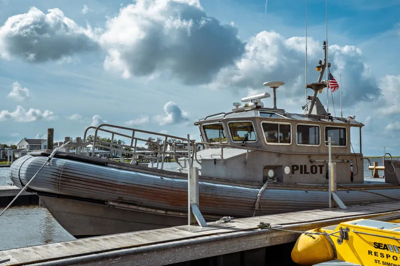 Slide: The Image of 2004 Kvichak Marine Industries Pilot boat docked under cloudy sky. - 2