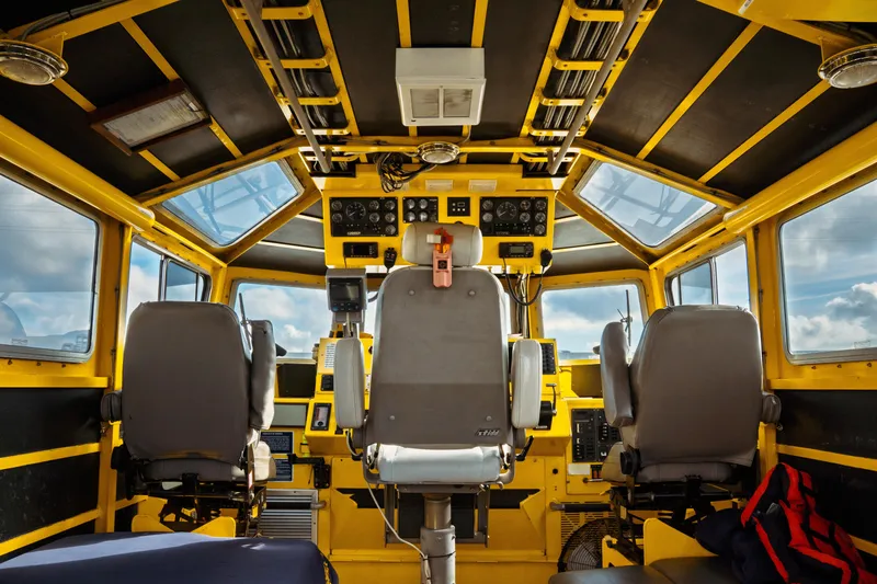 Slide: The Image of Interior of a 2004 Kvichak Marine Industries Pilot boat cockpit with control panels and seating. - 23