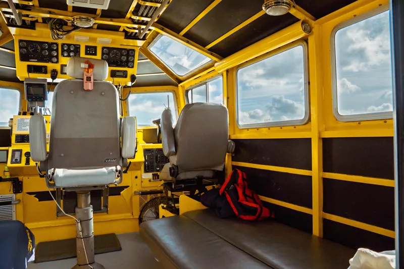 Slide: The Image of Interior of a 2004 Kvichak Marine Industries Pilot boat, featuring control panels and seating. - 24