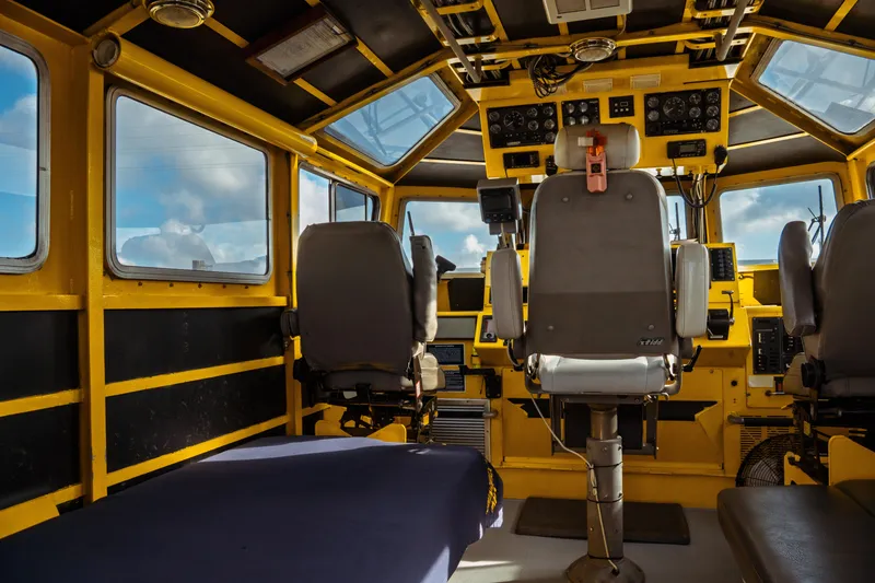 Slide: The Image of Interior of a 2004 Kvichak Marine Industries Pilot boat, featuring control panels and seating. - 25