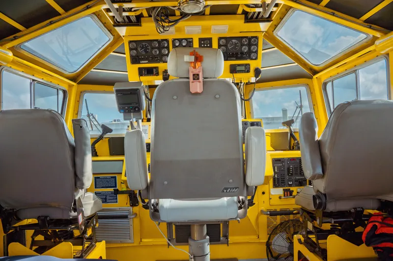 Slide: The Image of Interior of a 2004 Kvichak Marine Industries Pilot boat cockpit, featuring control panels and seating. - 29