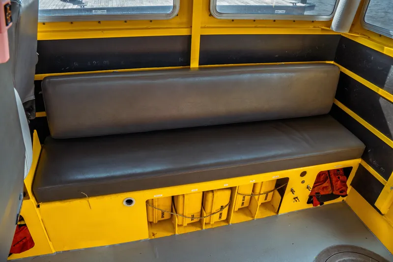 Slide: The Image of Interior of a 2004 Kvichak Marine Industries Pilot boat with yellow seating and storage compartments. - 43