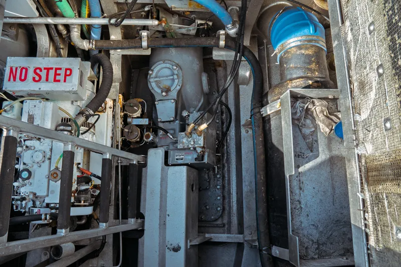 Slide: The Image of Engine compartment of a 2004 Kvichak Marine Industries Pilot boat, featuring mechanical components. - 49