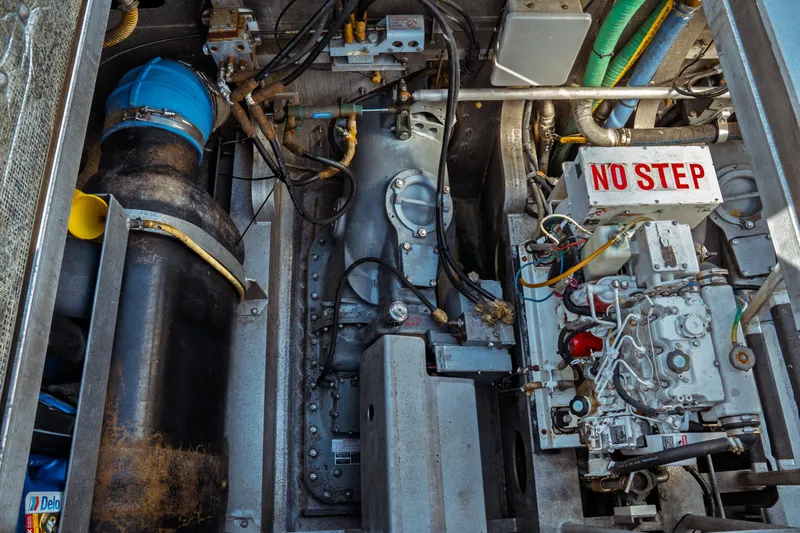 Slide: The Image of Engine compartment of a 2004 Kvichak Marine Industries Pilot boat, featuring mechanical components and "No Step" sign. - 50