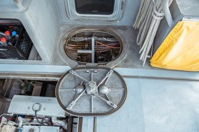 Slide: The Image of Engine compartment of a 2004 Kvichak Marine Industries Pilot boat, featuring mechanical components and storage. - 65