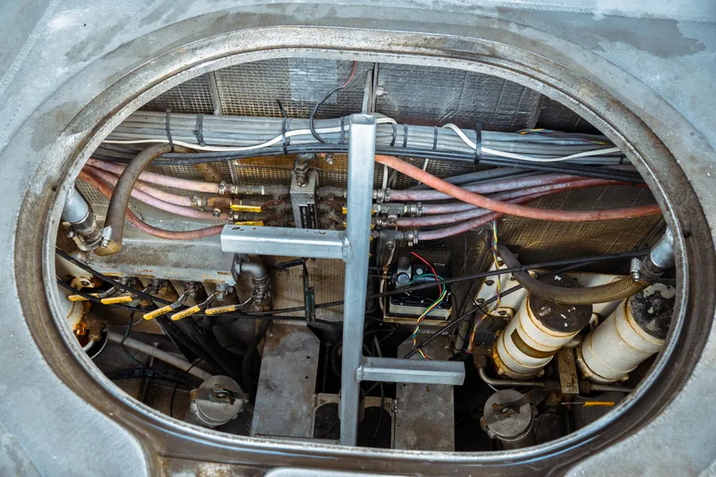 Slide: The Image of Engine compartment of a 2004 Kvichak Marine Industries Pilot boat, showing cables and hoses. - 66