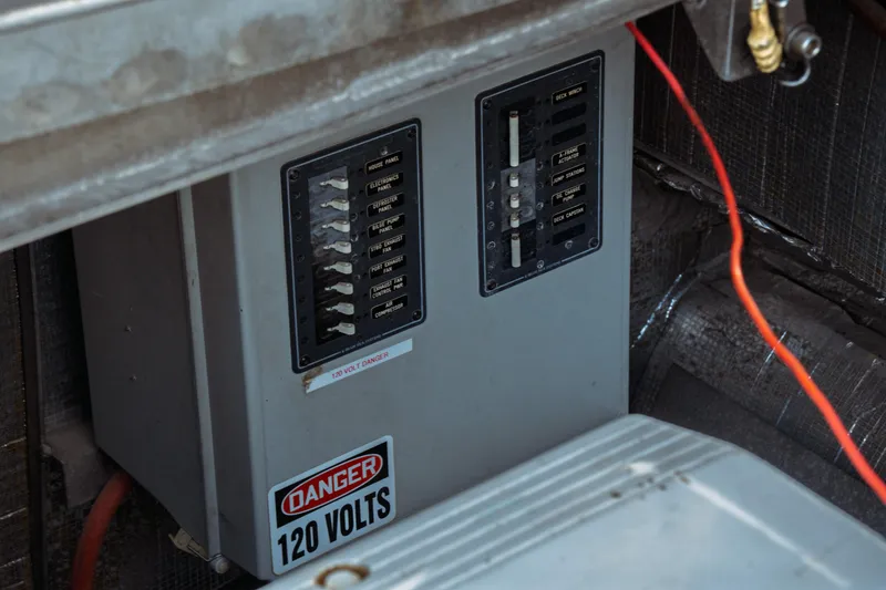 Slide: The Image of Electrical panel with 120 volts warning on a 2004 Kvichak Marine Industries Pilot boat. - 72