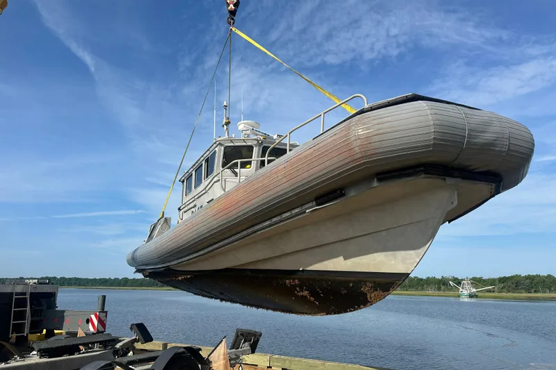 Slide: The Image of Custom 2004 Pilot boat being lifted by crane over water. - 74