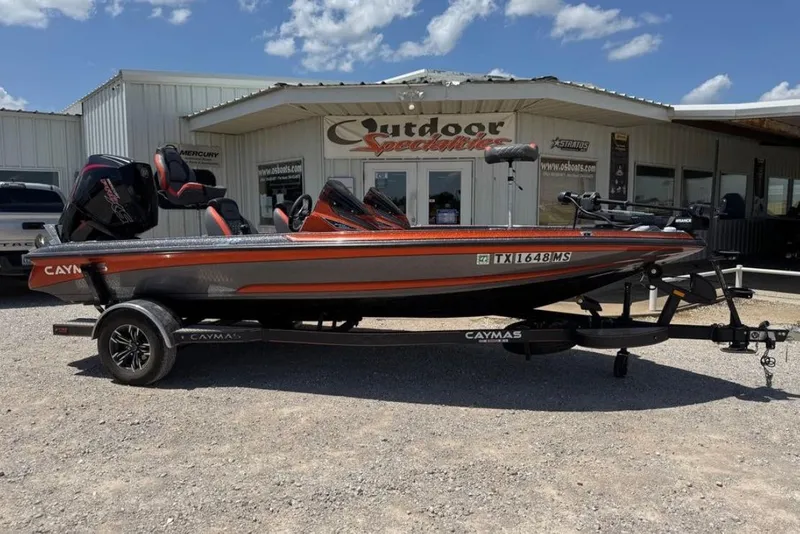 Slide: The Image of 2025 Caymas CX 18 Pro boat on trailer outside dealership under blue sky. - 1