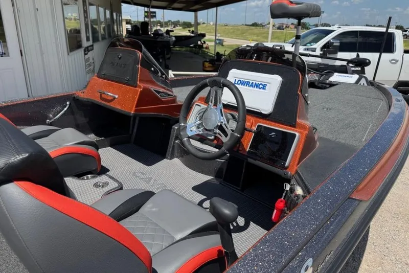 Slide: The Image of 2025 Caymas CX 18 Pro boat interior with steering wheel and Lowrance electronics. - 5