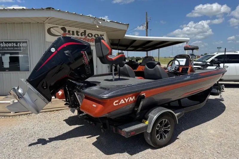 Slide: The Image of 2025 Caymas CX 18 Pro boat with powerful outboard motor, parked outdoors under clear sky. - 8