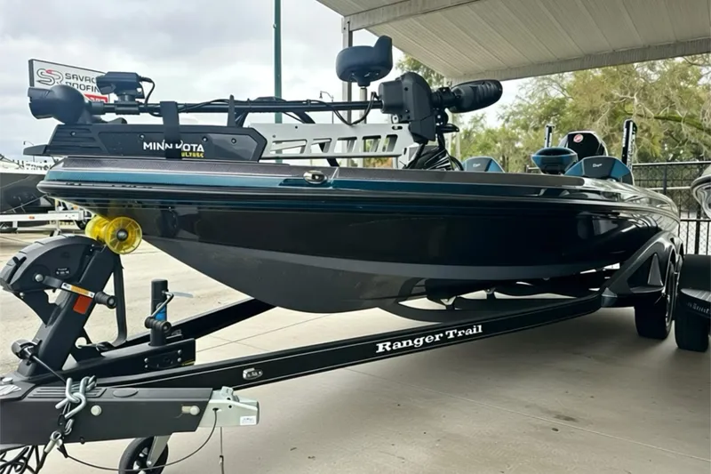 Slide: The Image of 2026 Ranger Z520 boat on trailer, featuring Minn Kota Ultrex motor, parked under shelter. - 16