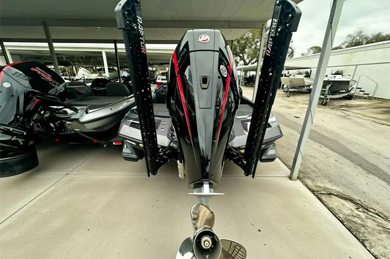 Slide: The Image of 2026 Ranger Z520 boat with powerful outboard motor and sleek design in a marina setting. - 17