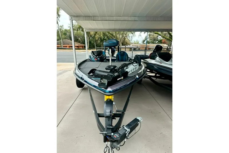 Slide: The Image of 2026 Ranger Z520 boat parked under a canopy, featuring advanced fishing equipment. - 18