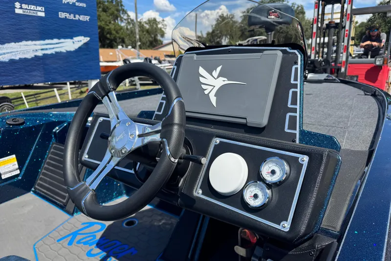 Slide: The Image of 2026 Ranger Z520 boat dashboard with steering wheel and gauges, featuring a sleek design. - 6