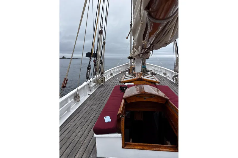 Slide: The Image of Deck view of 2004 Custom Luke Powell Pilot Cutter, featuring wooden details and rigging. - 20