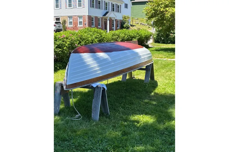 Slide: The Image of Upside-down Luke Powell Pilot Cutter boat on stands, grassy yard, sunny day. - 35