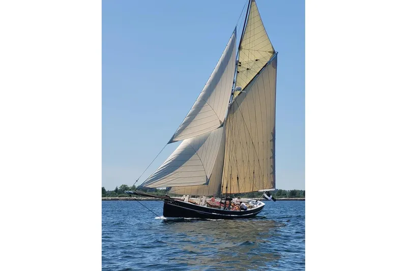 Slide: The Image of Custom 2004 Luke Powell Pilot Cutter sailing on open water under clear skies. - 5