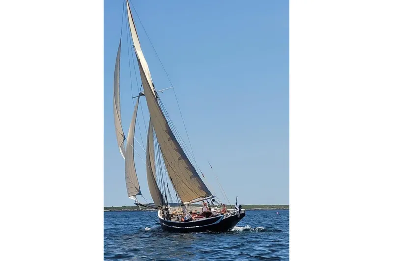 Slide: The Image of Custom 2004 Luke Powell Pilot Cutter sailing on open water under clear blue skies. - 8
