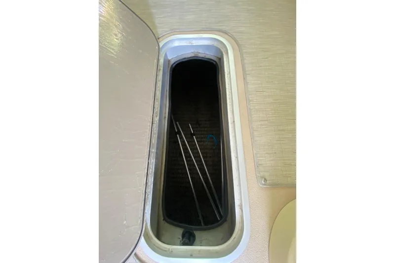 Slide: The Image of Open storage compartment on 2014 AquaPatio 220 WB boat, showing interior space. - 10