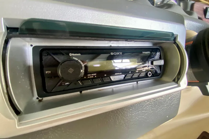 Slide: The Image of Sony stereo system in a 2014 AquaPatio 220 WB boat dashboard. - 14
