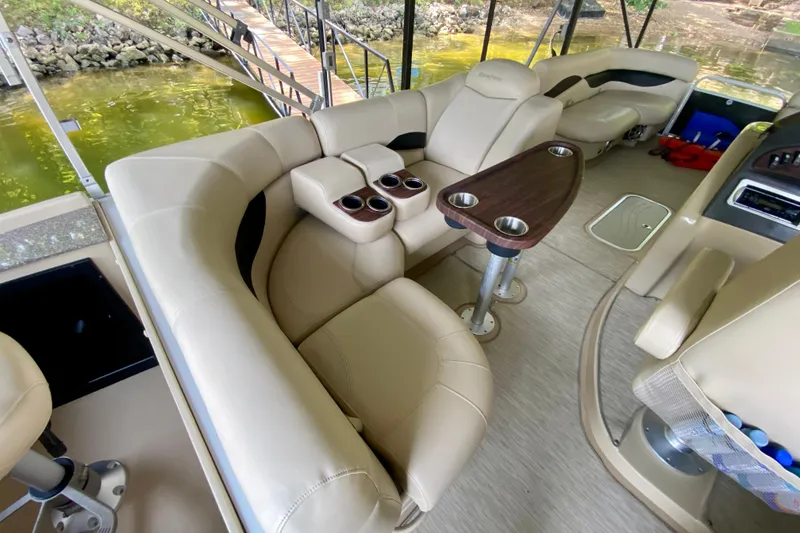Slide: The Image of Luxurious interior of 2014 AquaPatio 220 WB boat with beige seating and cup holders. - 15