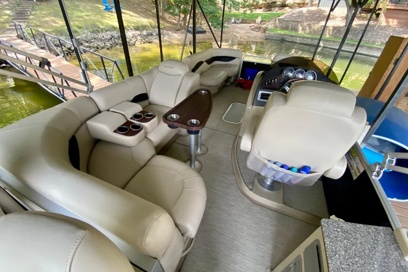 Slide: The Image of Luxurious 2014 AquaPatio 220 WB boat interior with plush seating and modern dashboard. - 20