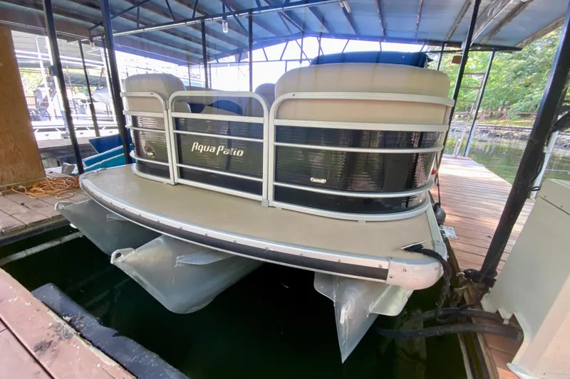 Slide: The Image of 2014 AquaPatio 220 WB pontoon boat docked in a covered marina. - 3