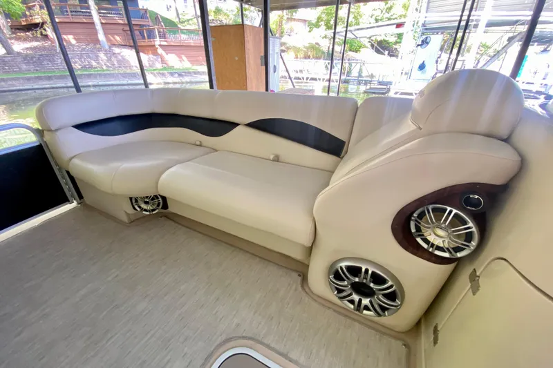 Slide: The Image of Luxurious seating on 2014 AquaPatio 220 WB boat with integrated speakers. - 6