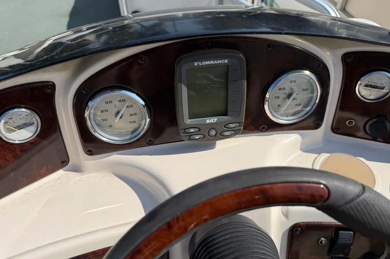 Slide: The Image of Dashboard of 2004 AquaPatio 240RE boat with gauges and Lowrance X47 display. - 20