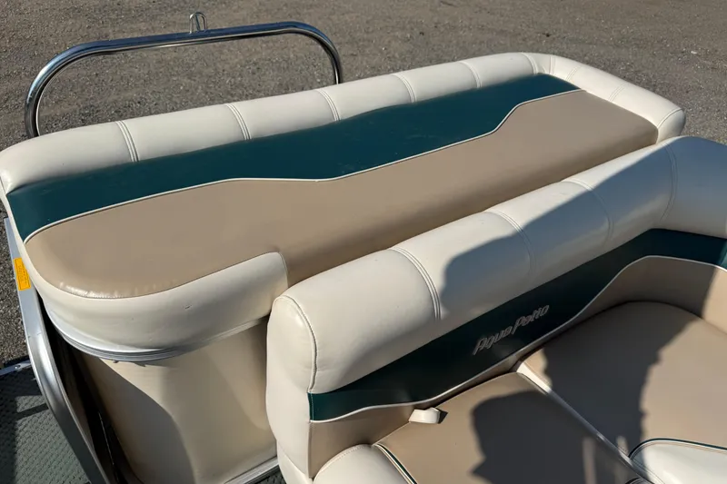 Slide: The Image of 2004 AquaPatio 240RE boat seating with beige and green upholstery. - 22