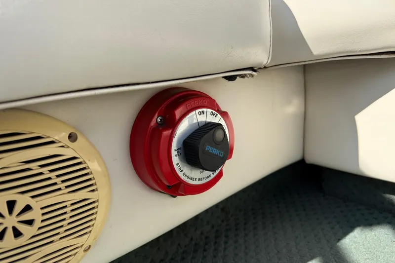 Slide: The Image of 2004 AquaPatio 240RE boat interior with Perko battery switch and speaker. - 23